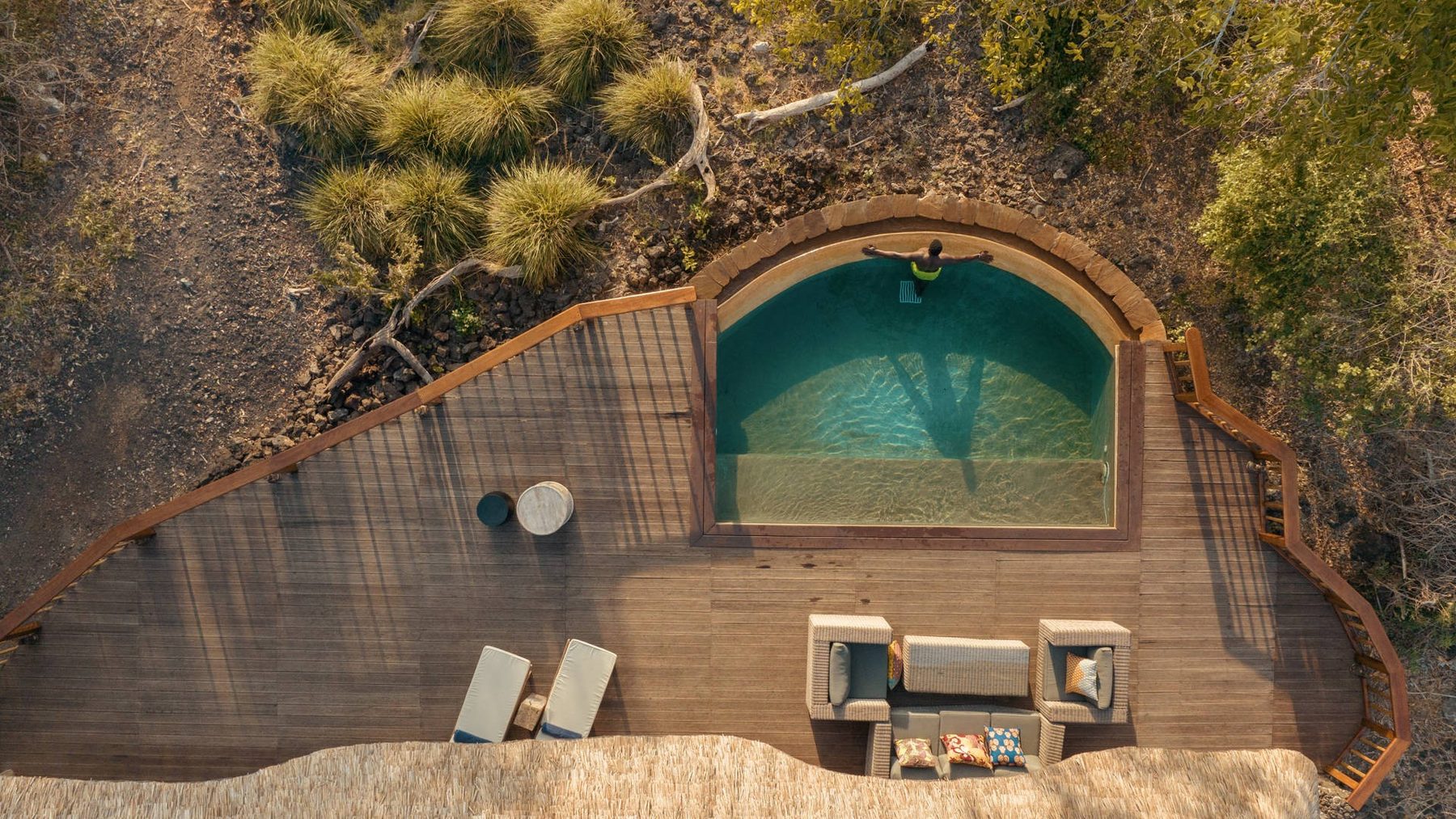 Aerial view of a suite deck with a private plunge pool and loungers among the bush at Finch Hattons