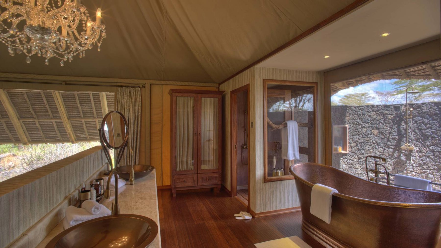 Copper bathtub and twin basins in a suite bathroom at Finch Hattons, with windows onto the bush