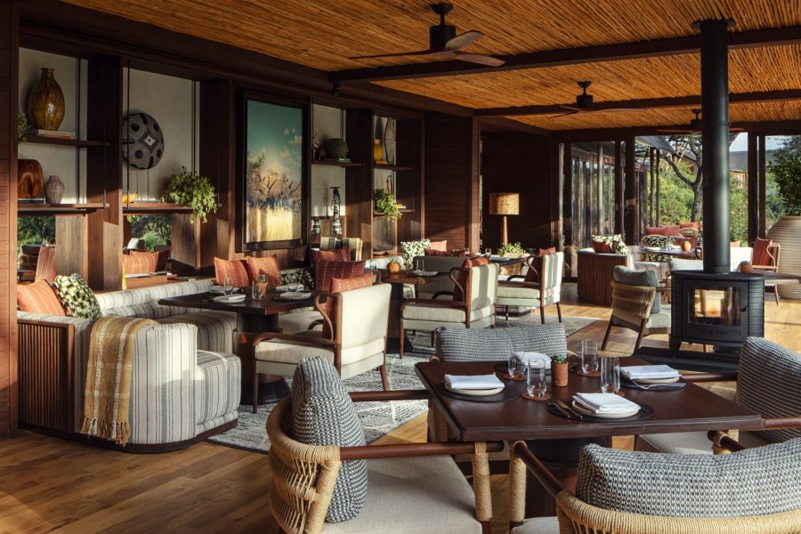 Dining room at JW Marriott Mount Kenya Rhino Reserve Safari Camp with a wood stove and a reed ceiling