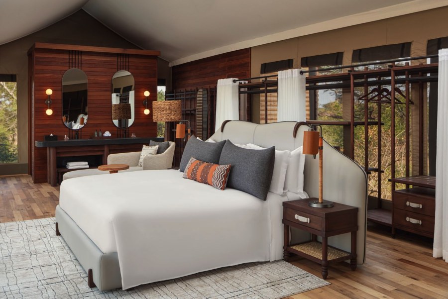 Tented suite at JW Marriott Mount Kenya Rhino Reserve Safari Camp with a white bed and twin mirrors