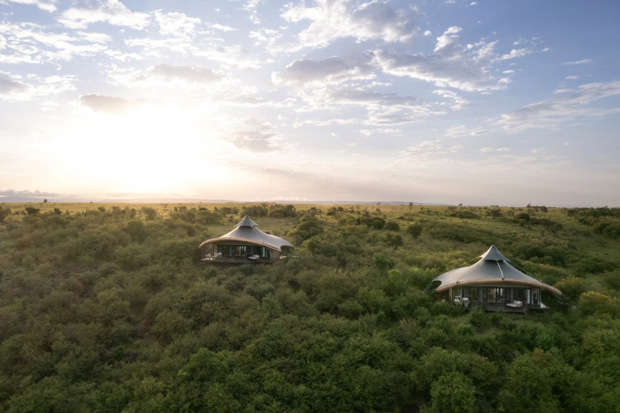 Two tents with curved roofs set in thick green bush at Mahali Mzuri in the Olare Motorogi Conservancy