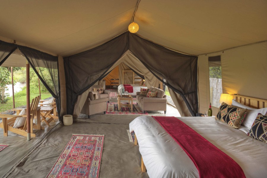 Family tent at Ol Pejeta Bush Camp with a double bed, a sitting area and a second bedroom through a mesh doorway