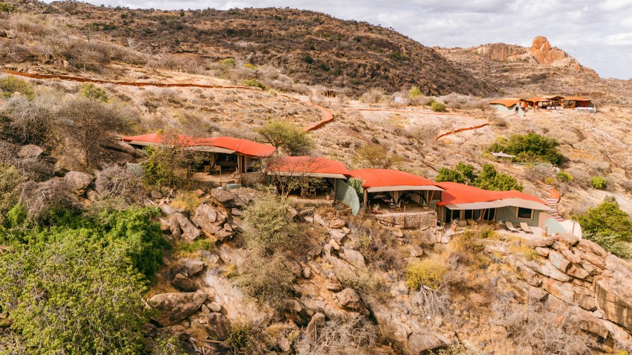 Red-roofed villas built among boulders on a rocky hillside at Saruni Samburu