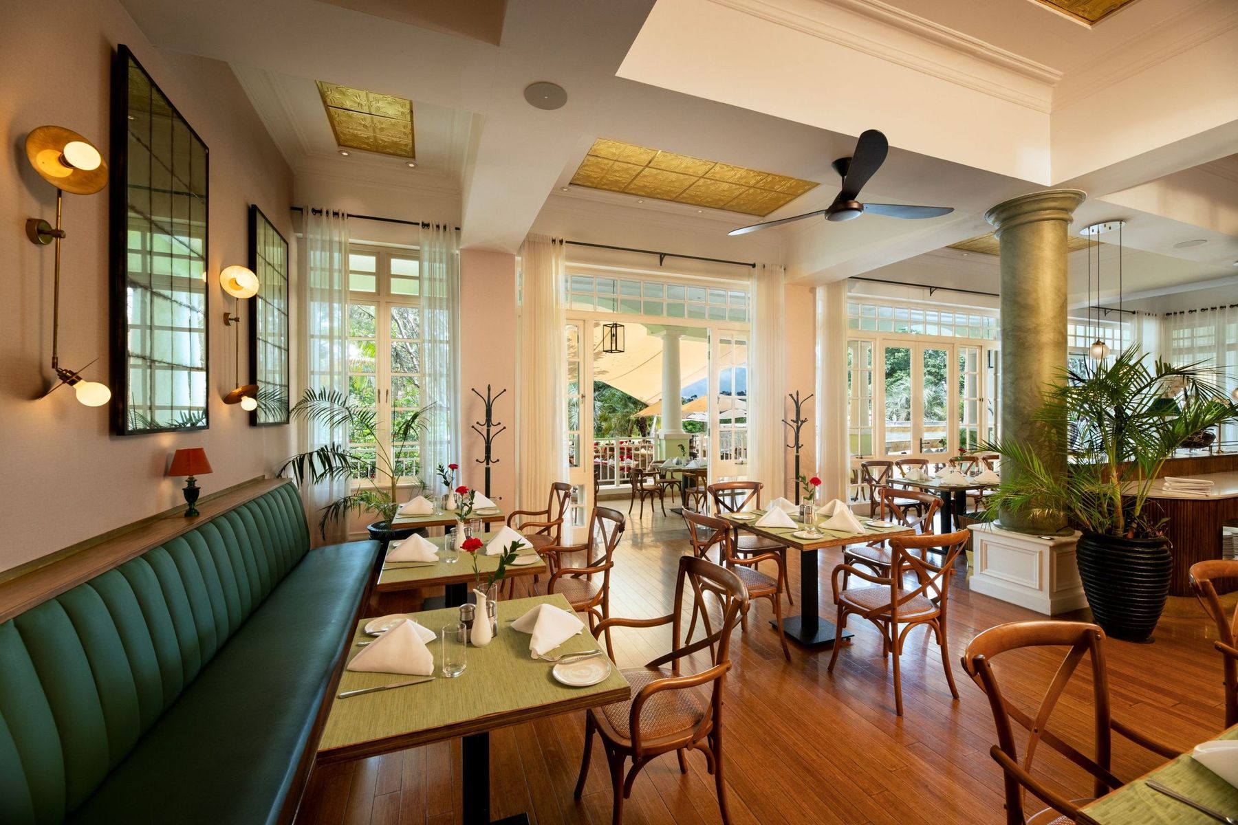 The Brasserie at Hemingways Nairobi, with green leather banquettes, bentwood chairs and tall windows