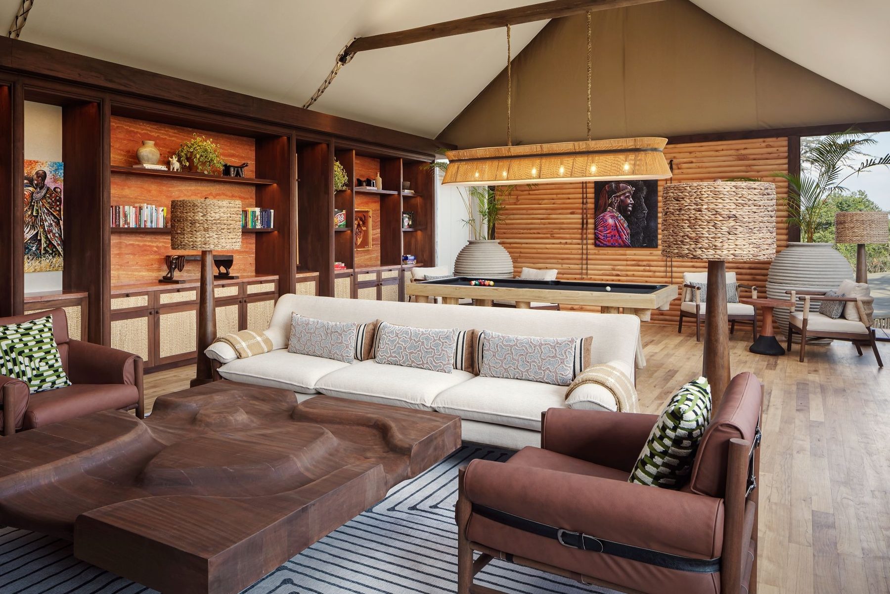 Main lounge under a tented roof at JW Marriott Mount Kenya Rhino Reserve Safari Camp, with cream sofas and leather armchairs