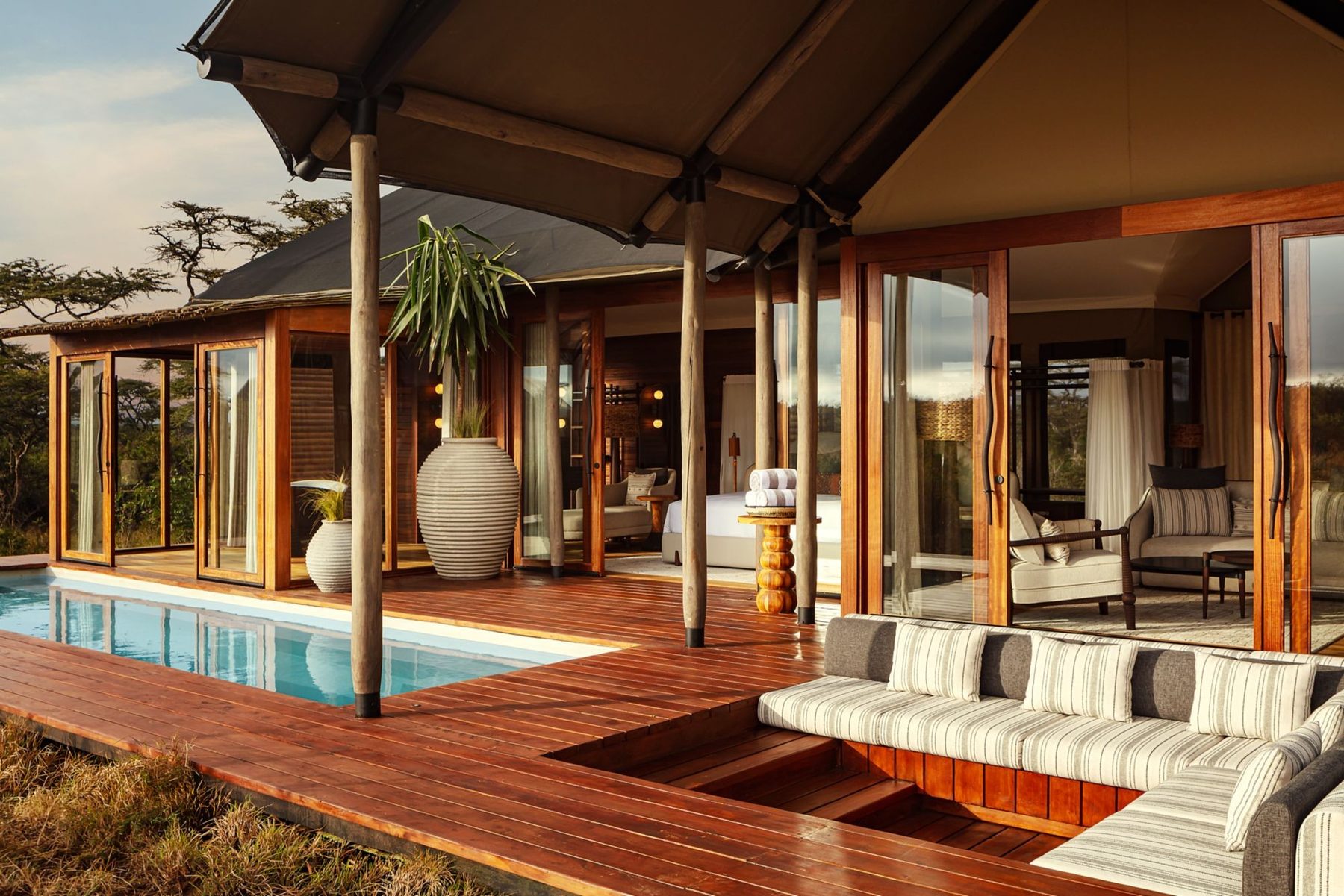Suite deck with a plunge pool and a sunken cushioned lounge at JW Marriott Mount Kenya Rhino Reserve Safari Camp