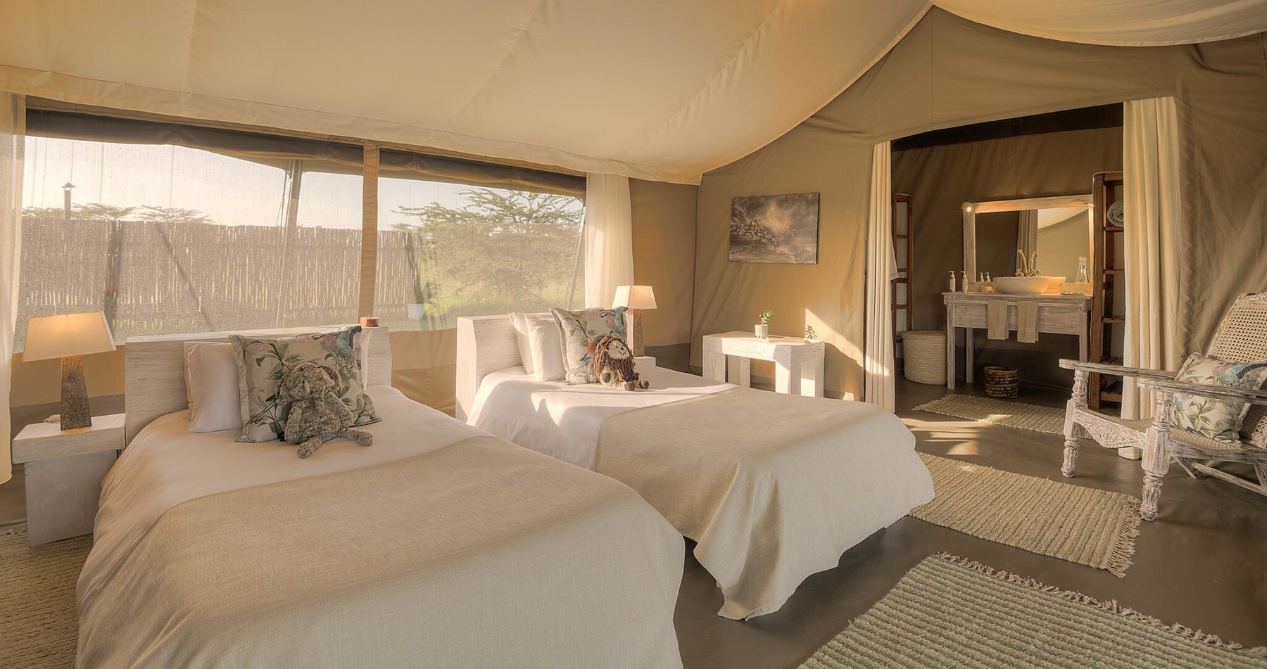 Twin beds in a canvas tent at Kicheche Bush Olare, with a dressing table and windows onto the bush