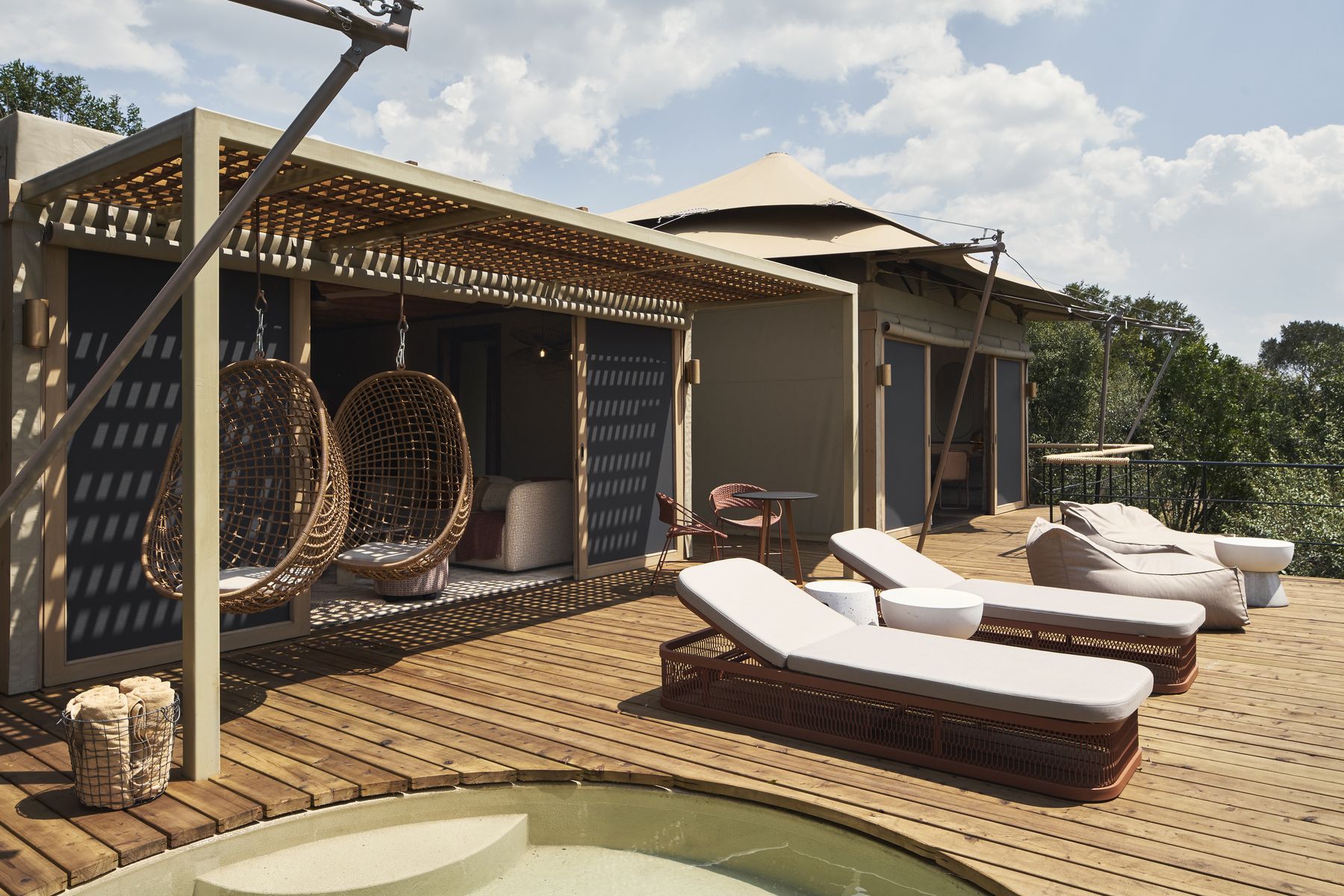 Deck of the two-bedroom suite at Kinara with hanging chairs, loungers and a plunge pool