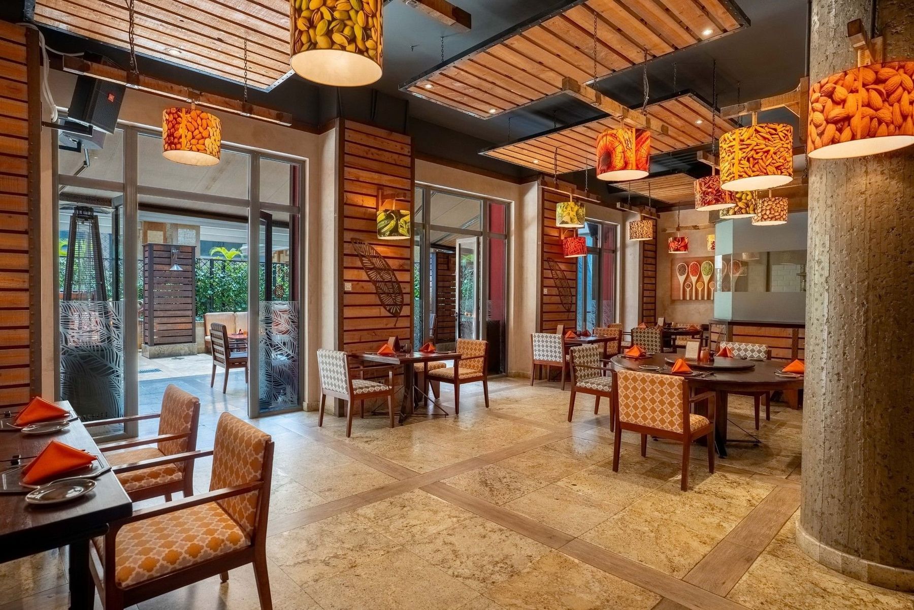 Herbs & Spices at Nairobi Serena Hotel, with orange lanterns, wooden screens and set tables