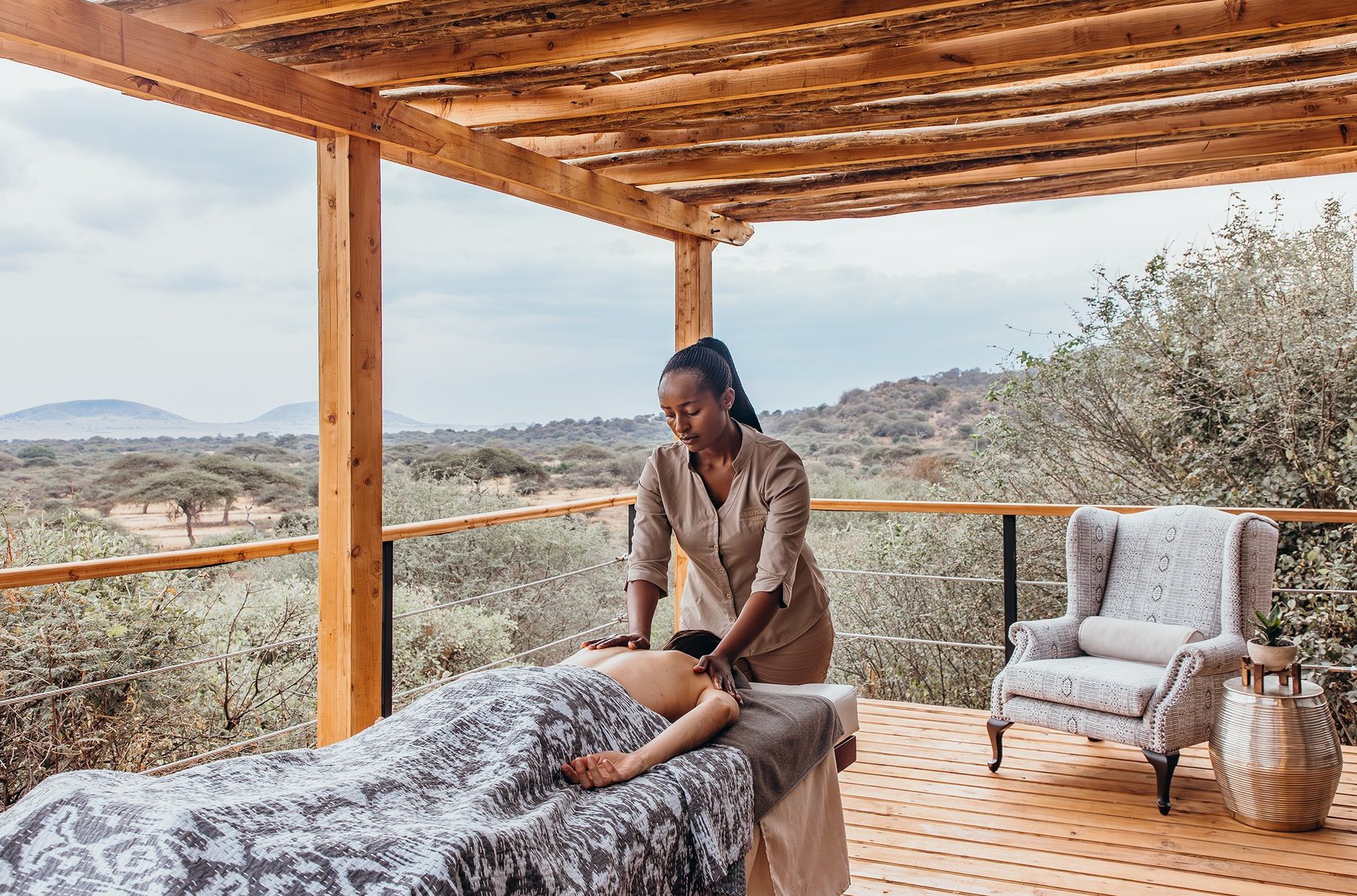 Massage on a shaded wooden deck overlooking the plains at ol Donyo Lodge