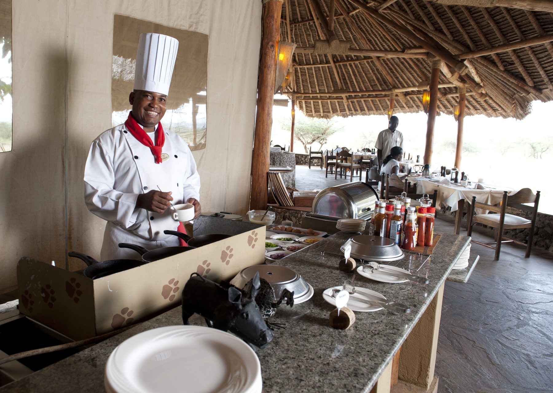 Chef cooking at the breakfast station in the open-sided dining area at Severin Safari Camp